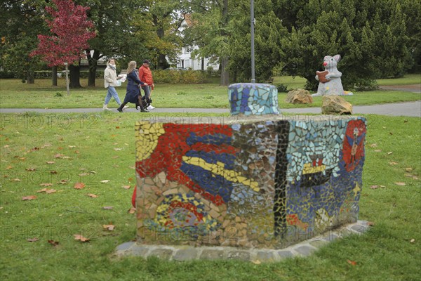 Pedestrian in the park with mouse figure reading a book, bookworm, literature, sculpture, public