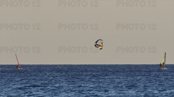 Wingfoiller, A windsurfer performs a jump in the air, Windsurfer, Meltemi windsurfing spot, Devils