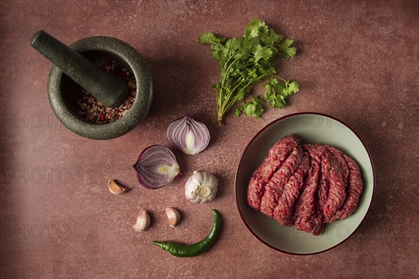 Fresh minced meat, raw, with spices and ingredients. on the table, preparation, top view