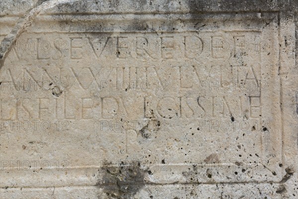 Close-up of carved letters on old slab of limestone at ancient 3rd century Roman ruins of Salona