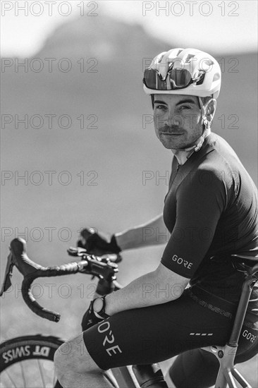 Road bike rider in spring near Halblech in the Allgäu in front of a picturesque backdrop of the