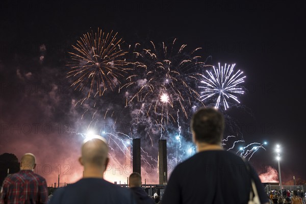 Spectators watch the fireworks at the Pyronale on the Maifeld at the Olympic Stadium, Berlin,