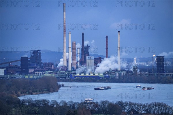 Industrial backdrop of the ThyssenKrupp Steel steelworks in Duisburg-Bruckhausen, cargo ships on