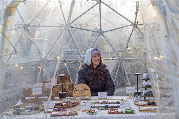 London, Ontario, Canada - A woman sells bracelets and other items in a shelter outside Covent