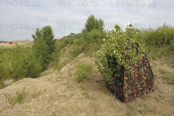 Camouflage tent of a nature photographer in a sand pit, camouflage hiding place, Lake Neusiedl