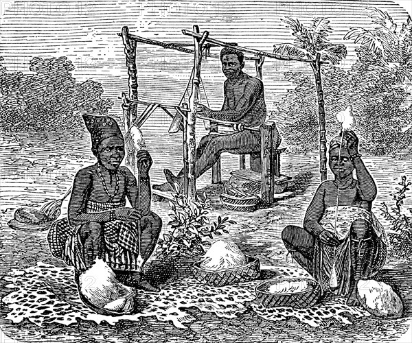 Spinning and weaving woman from the Ashanti tribe, West African ethnic group in the south of Ghana,