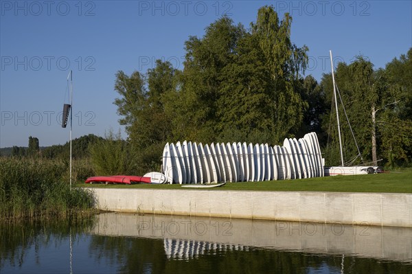 Surfboards standing next to each other in a stand on the Achterwasser, Ückeritz, Usedom Island,