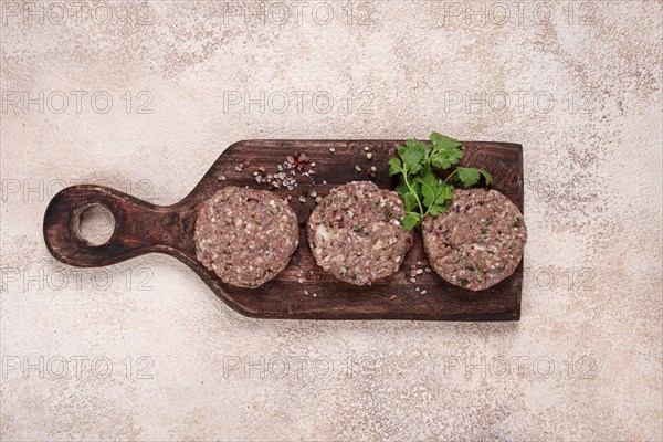 Raw cutlets, minced meat, on a chopping board, homemade, top view, no people