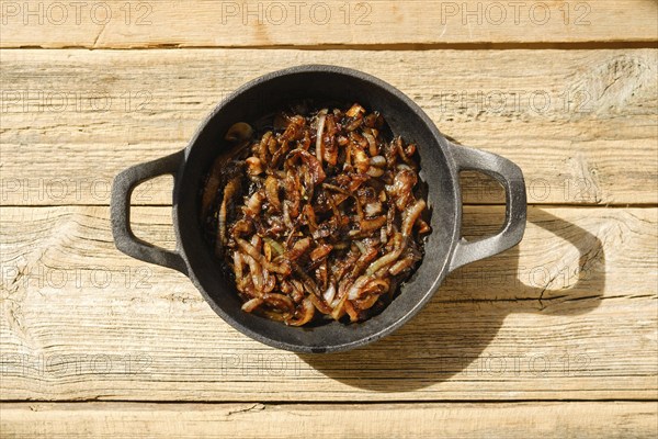 Top view of caramelized onion in cast iron frying pan