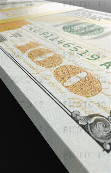 Ten thousand dollar stack of one hundred dollar bills close-up abstact.