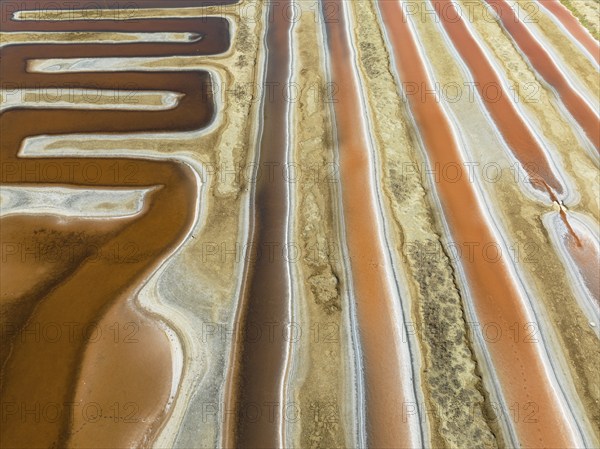 Saline ponds at the salt works near Chiclana de la Frontera. The orange-red colour depends on the