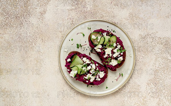 Sandwiches with beetroot hummus, cucumber and blue cheese, microgreens, rye bread, breakfast,