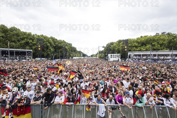 Football fans in the fan zone at the Brandenburg Tor during the quarter-final match between Germany