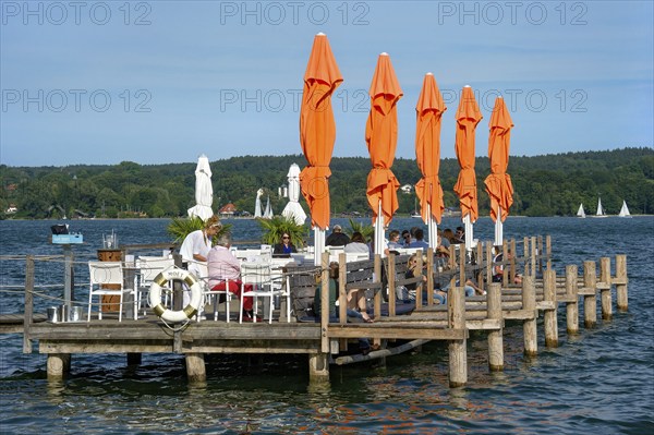 Old jetties with dining tables, lakeside restaurant, former Undosa wave pool, now H'ugo's Beach