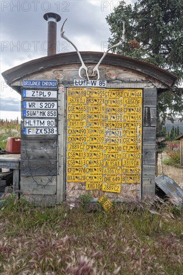 Funny wooden hut with car licence plates, collection, Top of the World Highway, Alaska, USA, North