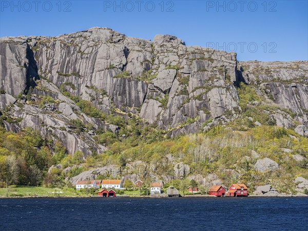 Steep granite mountains at the sea near Ana Sira, village Stornes, typcial coastal village, at