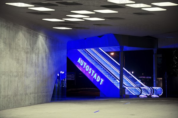 Illuminated escalator to the Autostadt under the phæno building at night, Wolfsburg, Lower Saxony,