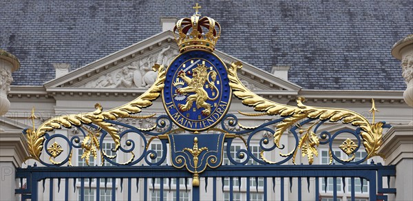 Coat of arms with the Dutch motto Je Maintiendrai, above the entrance to the Royal Palace