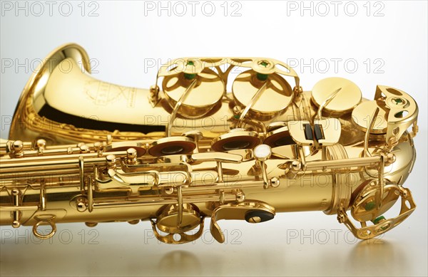 Saxophone in front of white background, detail, studio shot