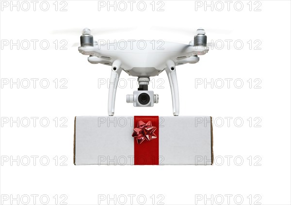 Unmanned UAV drone quadcopter delivering A package with a red ribbon and bow isolated on a white