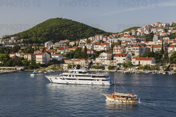 Suzana Zantium private yacht and sightseeing boat plus tan and white trim houses and villas with