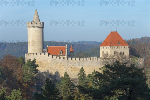 Medieval castle with red roofs on a wooded hill, Kokorin Castle, Kokorínský dul nature reserve,