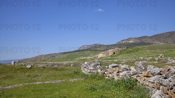 Remains, ruins in Hierapolis, in the background ruins of the ancient theatre Hieropolis, near