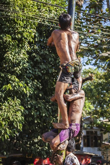 MYANMAR, JANUARY 4, 2014: Greasy pole climbing competition in village on Myanmar independence day