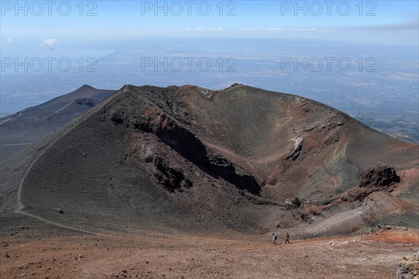 Hikers in the crater landscape of the volcano Etna, summit region, province of Catania, Sicily,