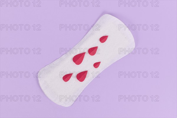 Female period concept with panty liner with symbolic paper blood