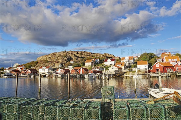 Lobster cages, harbour and small wooden houses in the autumn evening light, Fjällbacka, Bohuslän,