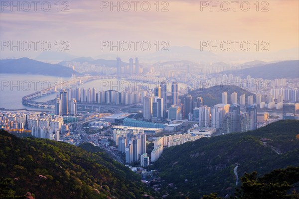 Busan cityscape with skyscrapers and Gwangan Bridge on sunset from Jangsan peak. Busan, South