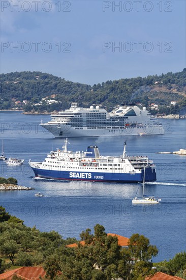 Cruise ship ferry and boats in the sea off the Mediterranean island of Skiathos, Greece, Europe