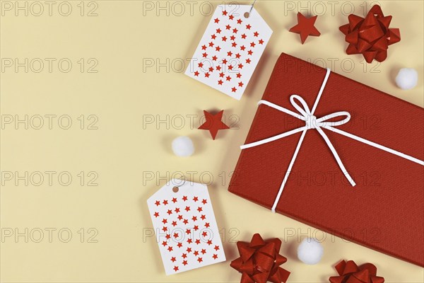 Christmas present gift wrapping concept with red gift box, ribbons, gift labels and white snow