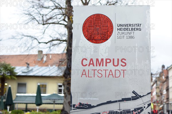 Heidelberg, Germany, March 2019: Informational sign with red university emblem and words University