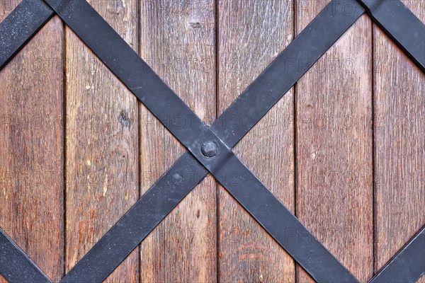 Weathered wood background with iron bars and brown colored planks