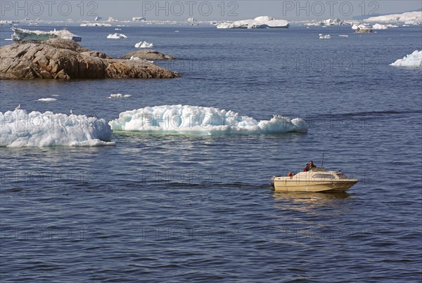 Small boat between icebergs and rocks, Ilulissat, Disko Bay, Denmark, Greenland, North America