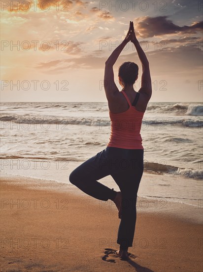Vintage retro effect filtered hipster style image of Yoga outdoors, sporty fit woman doing Hatha