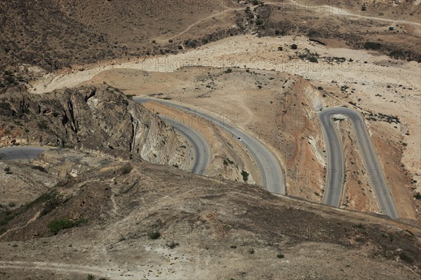 Serpentine road on the way to Yemen, landscape of southern Dhofar, Jabal al-Qamar, Oman, Asia