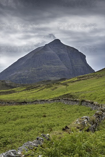 Old dry stone wall in front of mountain top Sàil Gharb, one Quinag's three separate Corbett summits