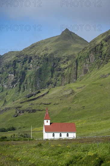 Vik Church, Víkurkirkja, between green mountains, Vík, South Iceland, Iceland, Europe