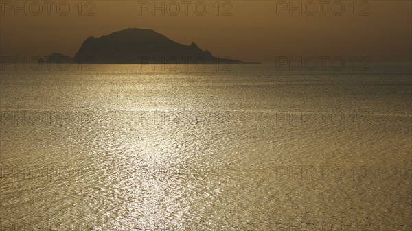 Santa Marina Salina, sunrise, sun rises behind Panarea, Panarea island near, light reflections on