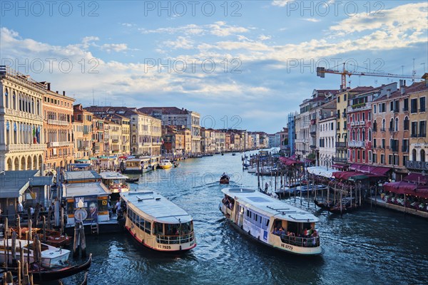 VENICE, ITALY, JUNE 27, 2018: Grand Canal with boats, vaporetto and gondolas on sunset from Rialto