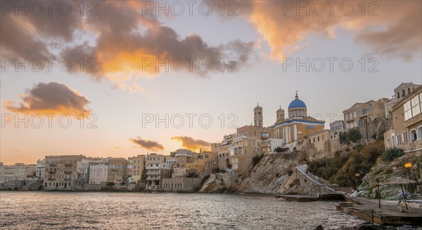 View of the village with the Greek Orthodox church of Agios Nikolaos, Asteria Beach, at sunset with