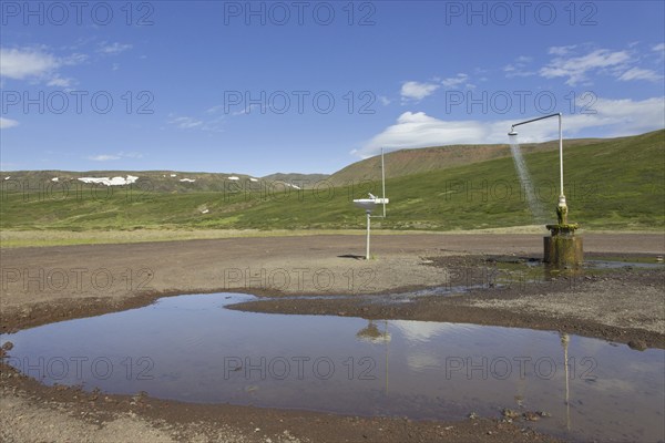 Shower and sink with hot water at Krafla, volcanic caldera in the Myvatn Geothermal Area in summer,