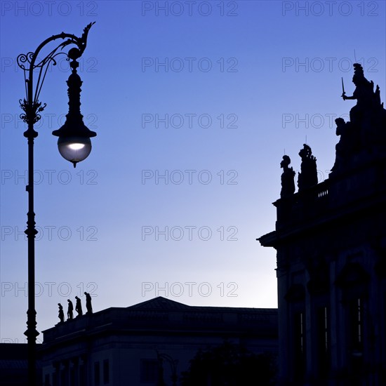 Old Berlin gas lanterns in the street Unter den Linden in the blue hour at the German Historical