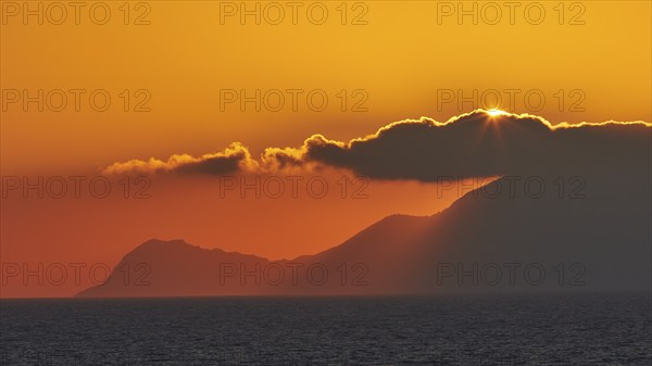 Sunset, sun disc behind clouds, Marettimo Island, Levanzo, Egadi Islands, Sicily, Italy, Europe