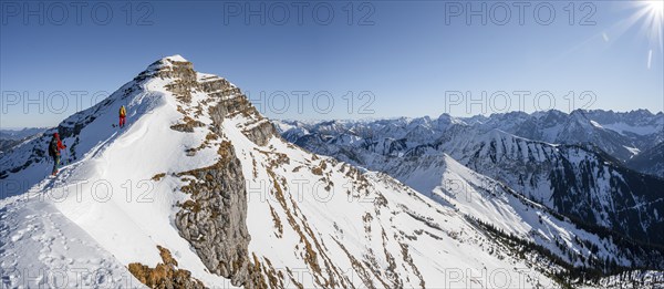 Two ski tourers on a snow-covered mountain ridge, summit of Schafreuter, view of snow-covered