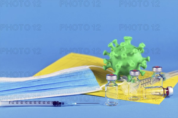 Corina virus booster vaccination concept with 4 vials and syringes, vaccination passport, virus