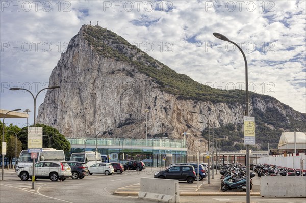 City view with prominent rock and passing cars under a cloudy sky, Gibraltar, Europe